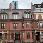 Three story brick townhouse buildings.