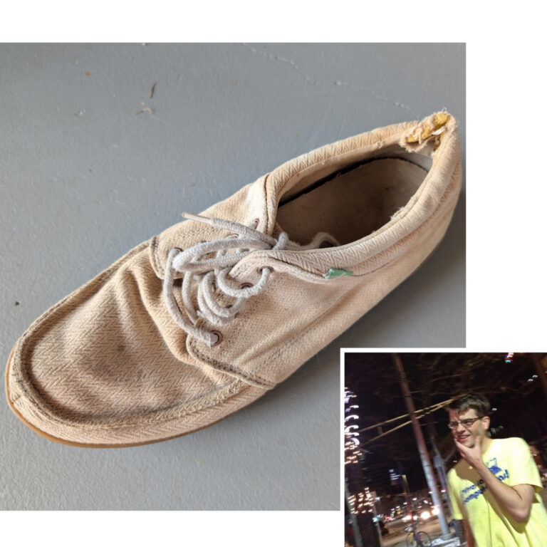 A worn tan shoe with white laces on a gray background. At lower right, a nested photograph of a white man with short dark hair on the icy Cambridge sidewalk in 2014, reflecting on the fact that he'd just given away one shoe.